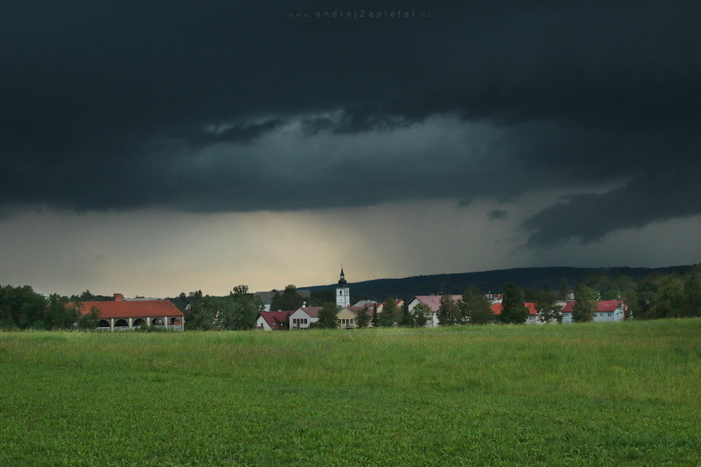 Dusk over a Village (On the photo:  kostel, louka, mraky, léto)