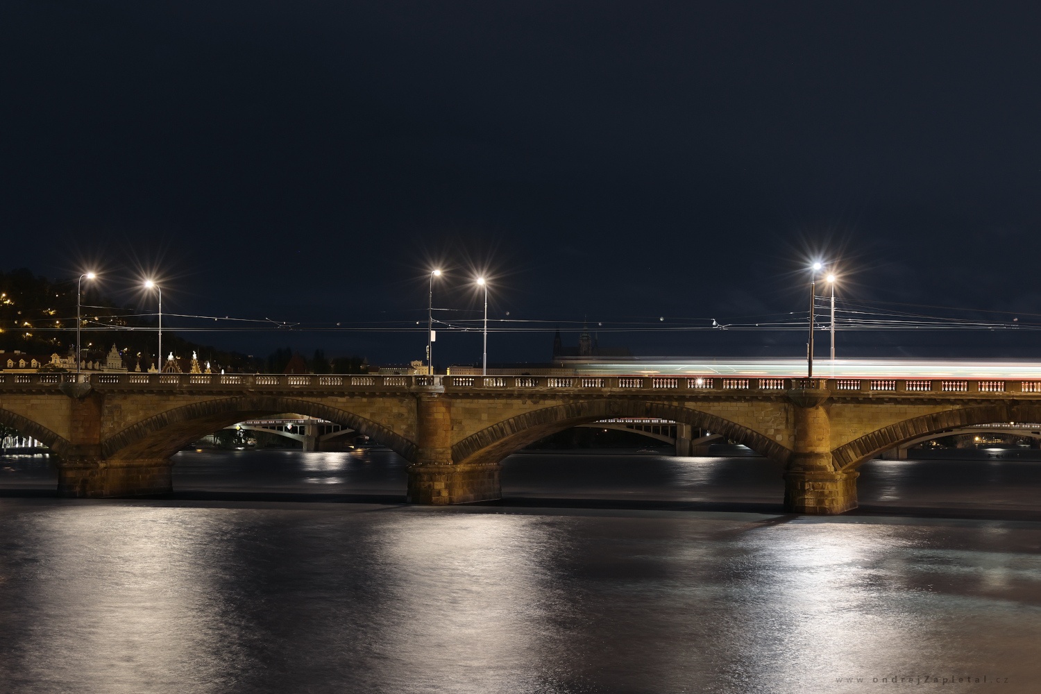 Tram under the Bridge Lights (On the photo:  řeka, most, noc, tramvaj, elektřina, praha, město)