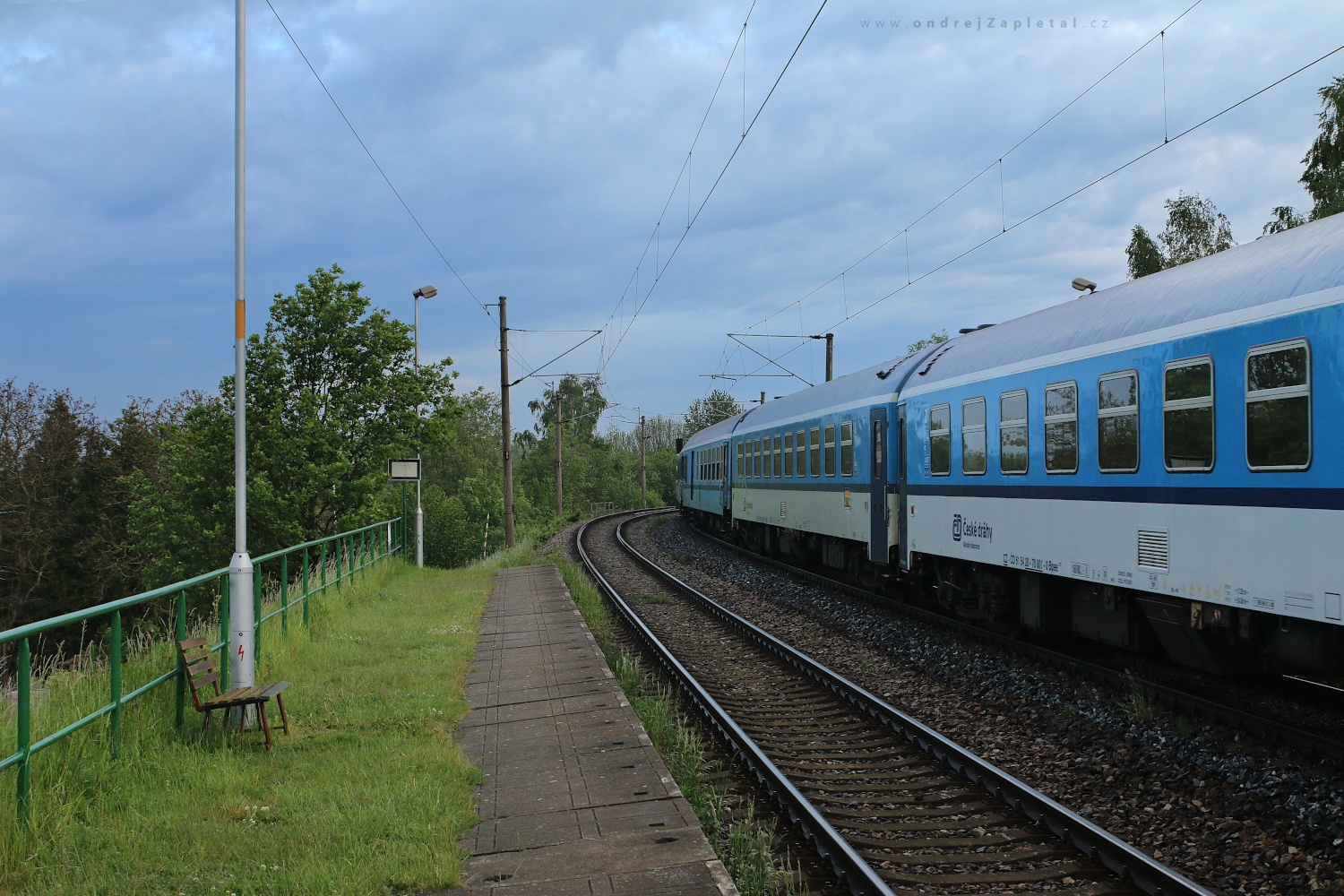 Express Rushing through a Stop (On the photo:  (Rural photography) vlak, venkov, elektřina, jaro)